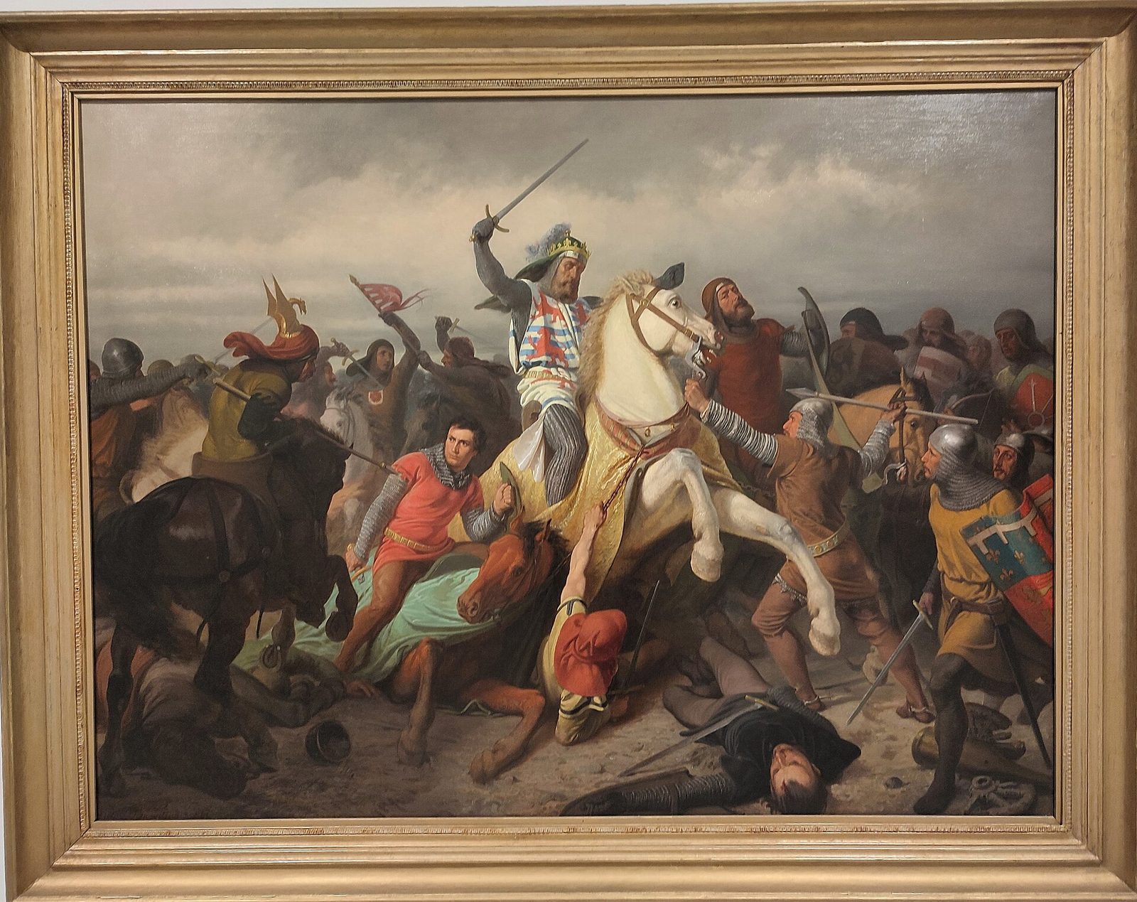 A painting of an armoured king on a white horse charging into a melee of knights.