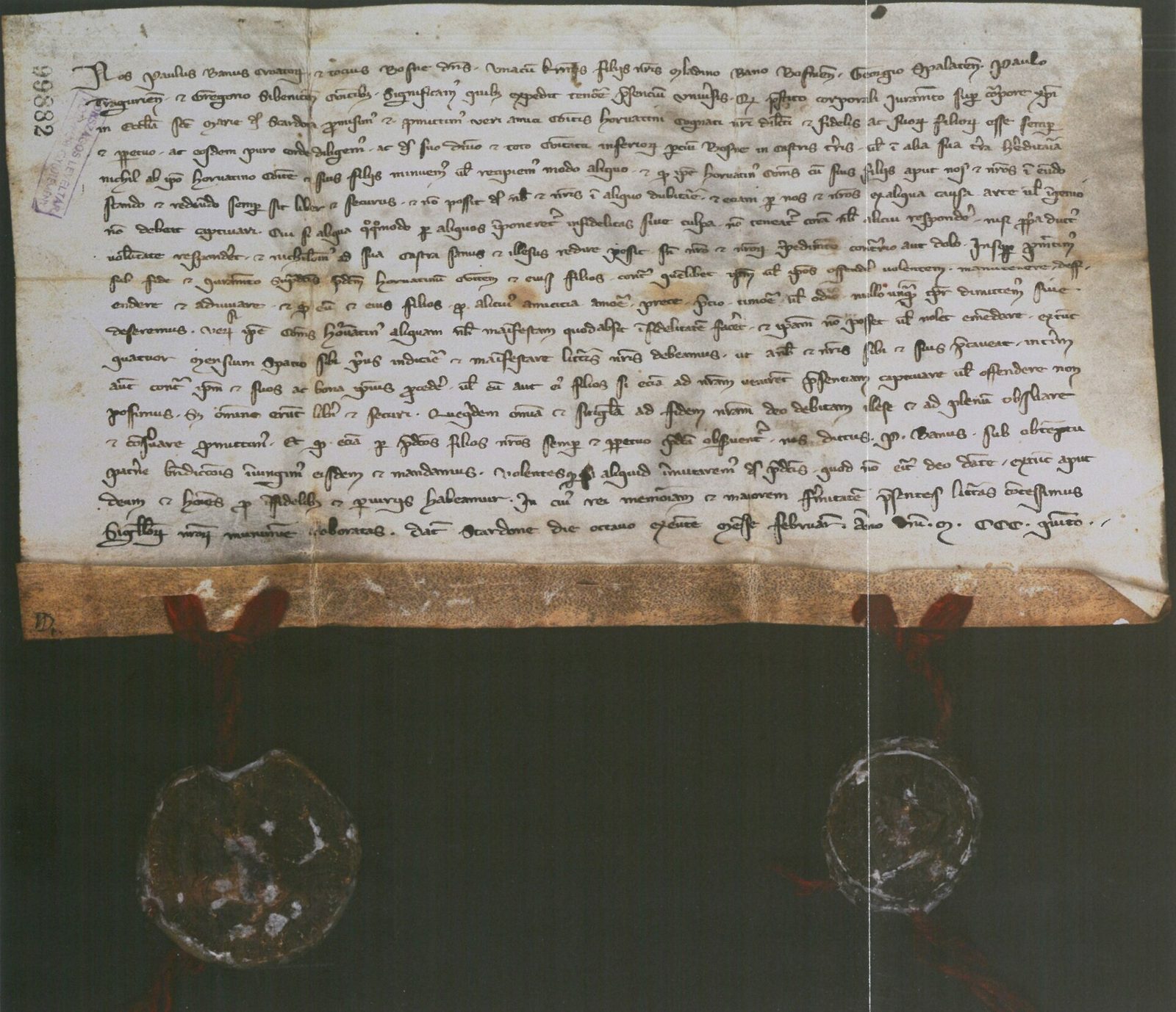 A parchment charter in Latin minuscule with two wax seals hanging from red cords.