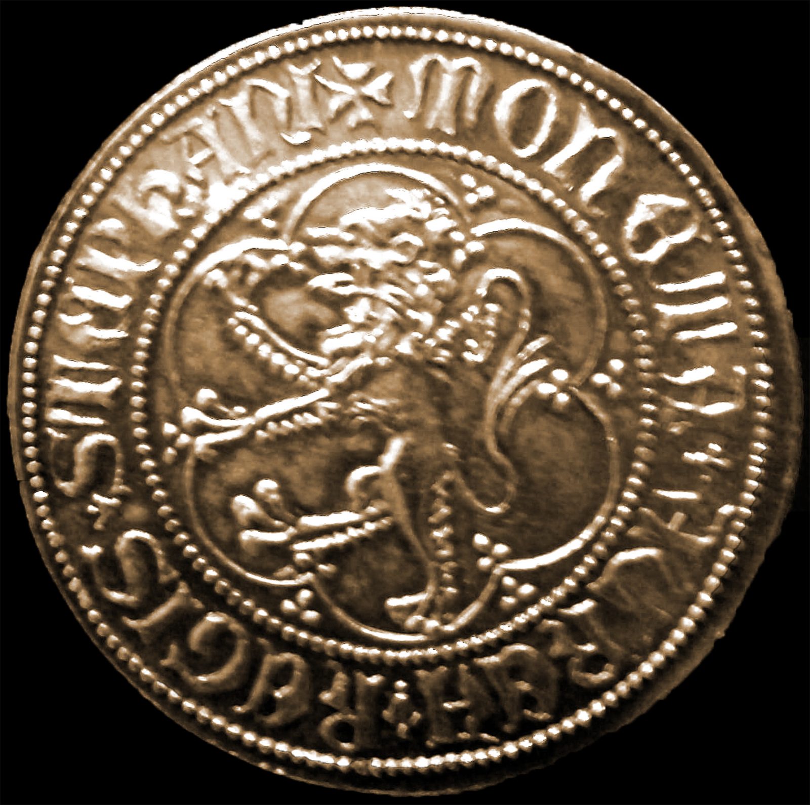 A gold coin showing a crowned lion rampant inside a ring of lettering.
