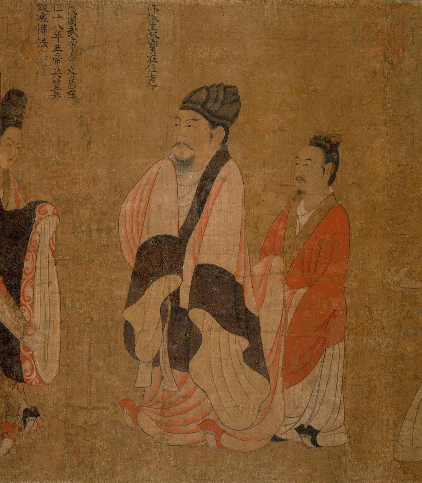 A painted standing ruler in a dark robe and a soft cap, with an attendant.
