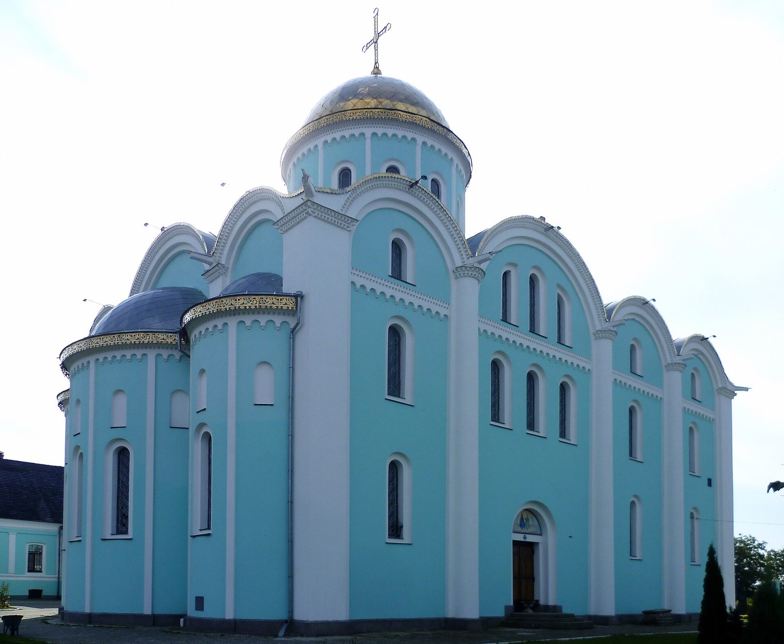 A pale blue cathedral with white trim, a central dome and rounded gables.