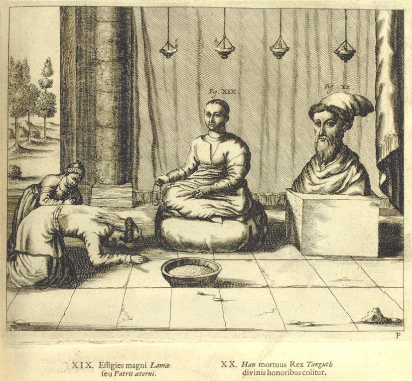 An engraving of a figure seated cross-legged on cushions under hanging lamps, a man kneeling before him.