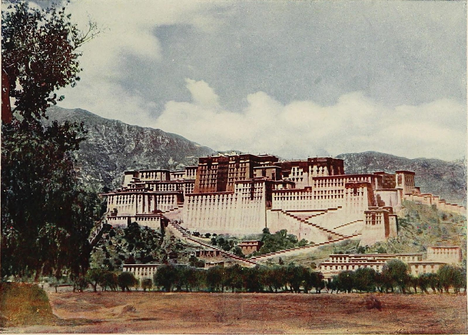 A tinted photograph of a great white and red palace on a hill above trees.