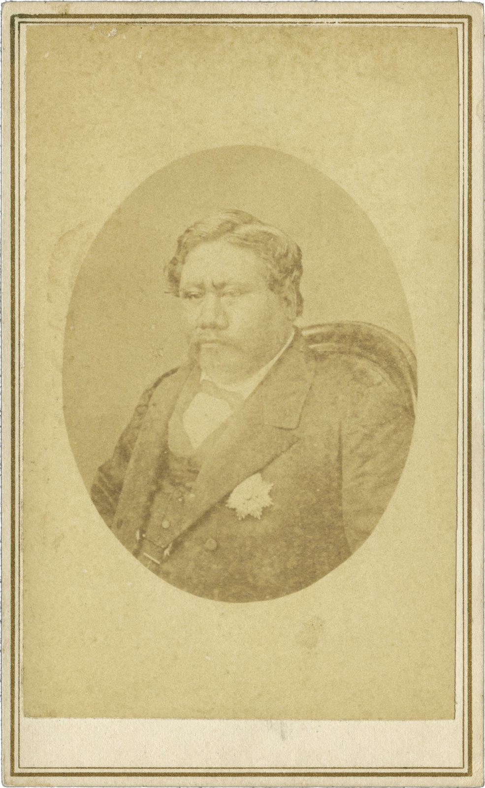 A carte-de-visite photograph of a heavy-set man with a moustache in a dark coat, in an oval.