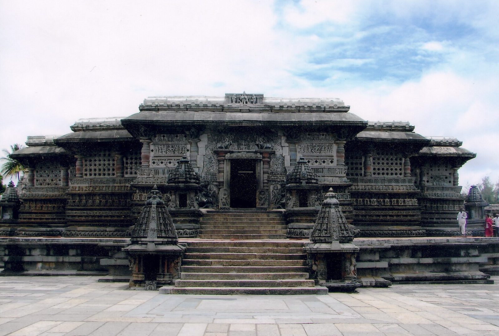 A star-shaped stone temple on a raised platform reached by a flight of steps.