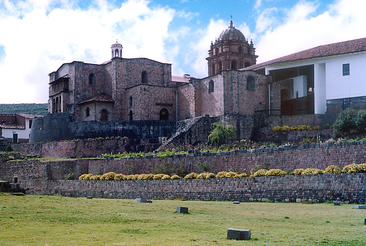 Inca stone terraces and walls supporting a colonial church and convent.