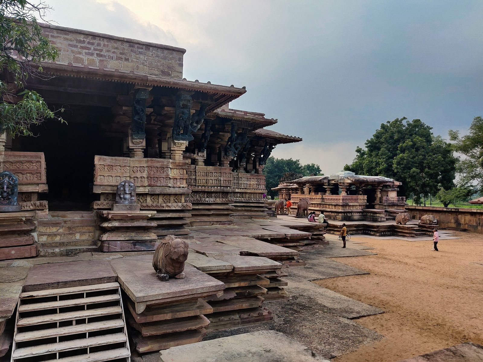 A stone temple on a star-shaped platform with bracket figures under its eaves.