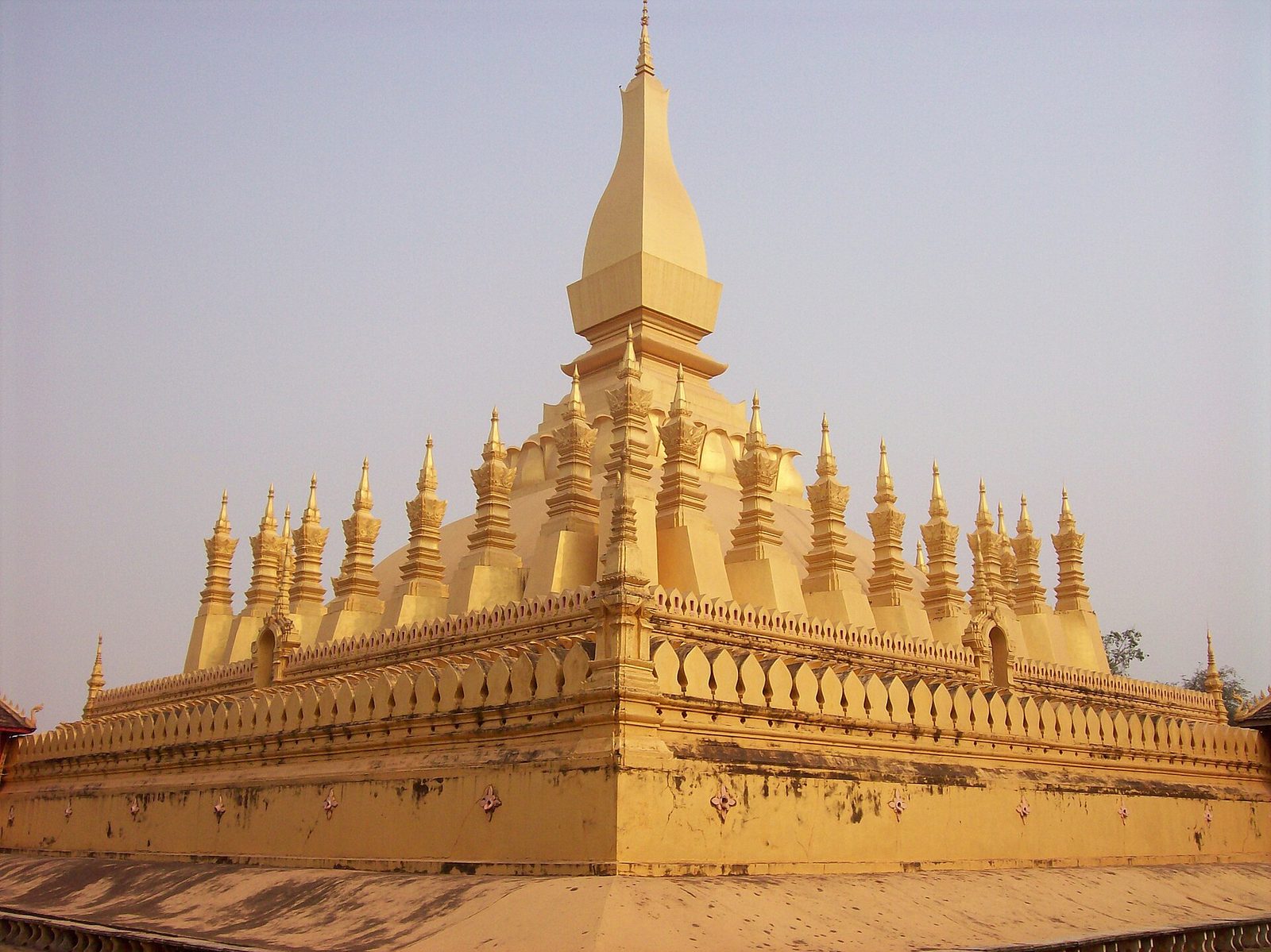 A broad gilded stupa surrounded by small spires.