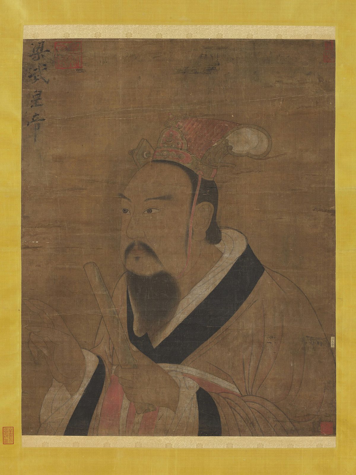 A painted half-length portrait of a bearded man in a dark robe and a red cap, on silk.