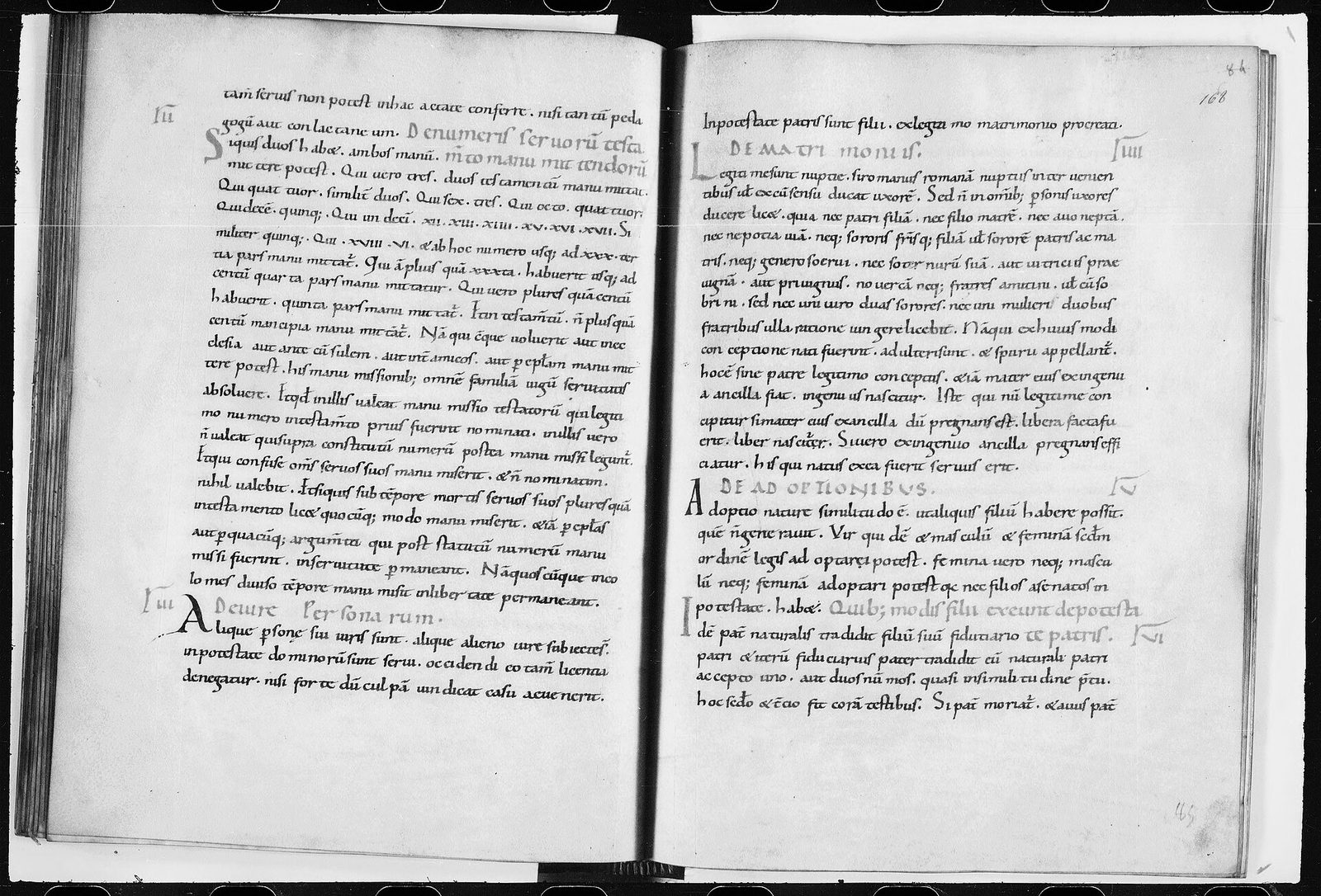 An open early medieval manuscript, both pages in a single column of small Latin hand with short rubricated headings and numbers in the margin.