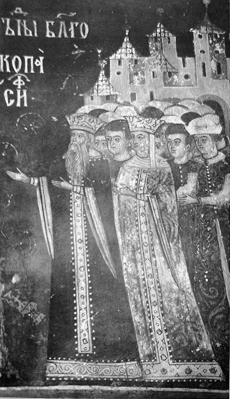 A black-and-white photograph of a fresco of a crowned prince and princess in long robes, with attendants and a church behind.