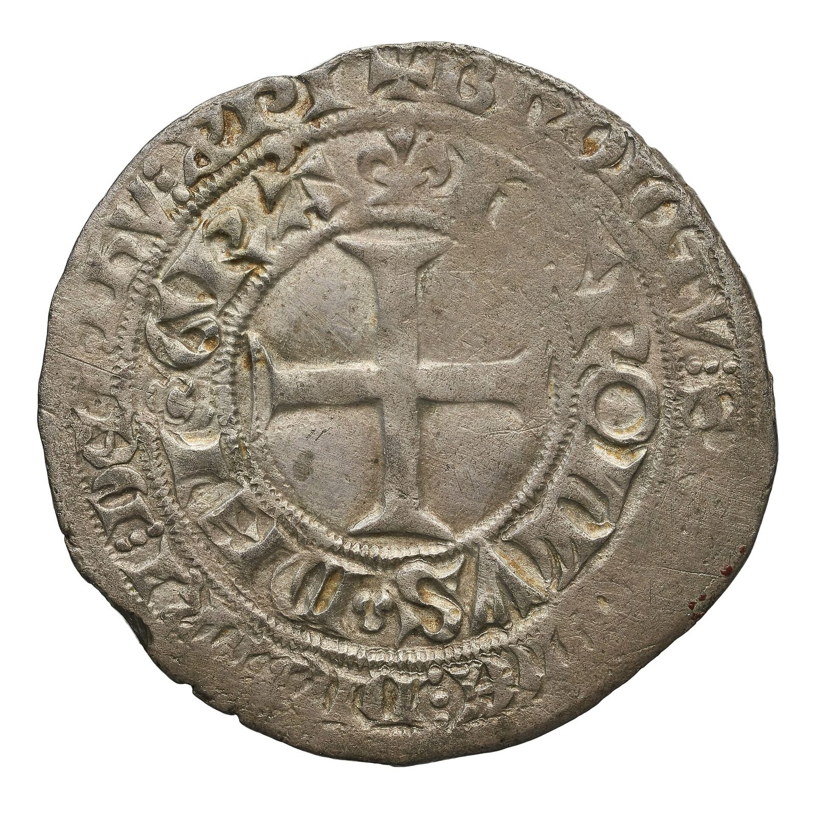 A silver coin with a cross at its centre and a ring of lettering around the rim.