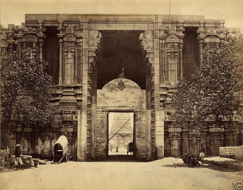 An old photograph of a massive carved temple gateway with a tall doorway.
