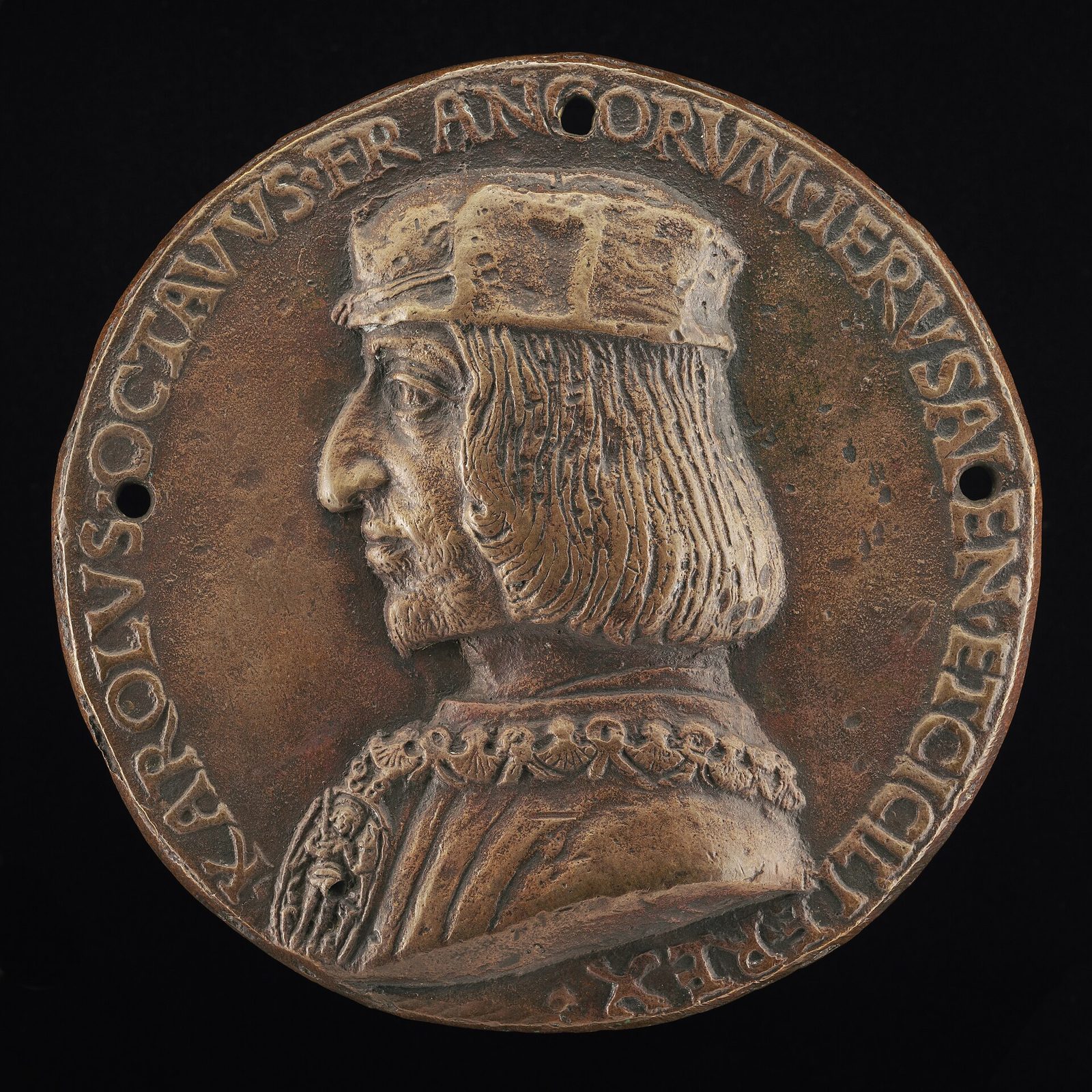 A bronze portrait medal showing a man in profile with a long nose and heavy jaw under a cap, encircled by a Latin inscription.