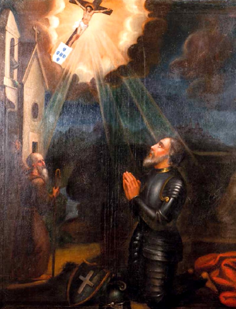 A painting of a kneeling knight in armour looking up at a vision of Christ on the cross in a burst of light, a hermit beside him.