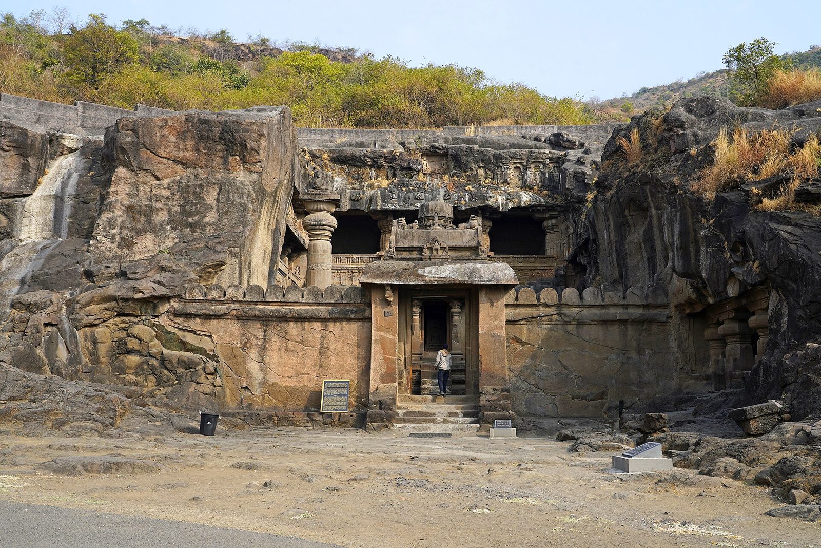 A two-storey rock-cut Jain temple court in a cliff face.