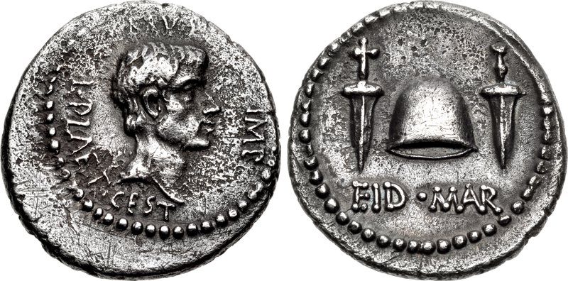 The two faces of a silver coin: a bearded head in right profile, and a cap between two daggers with the letters EID MAR beneath.
