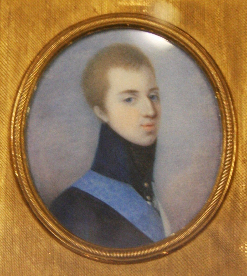A portrait of a young man with short dark hair in a uniform coat with a star.