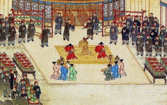 A painting of a court audience in a pavilion with officials kneeling before an emperor.