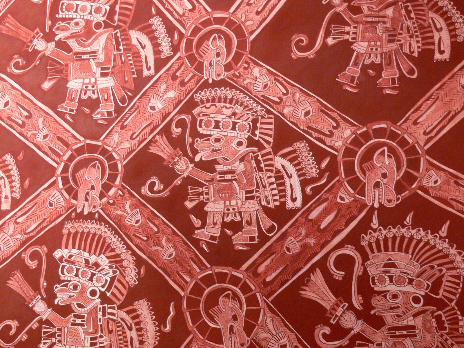 A red mural with repeated figures of costumed warriors inside a diamond lattice.