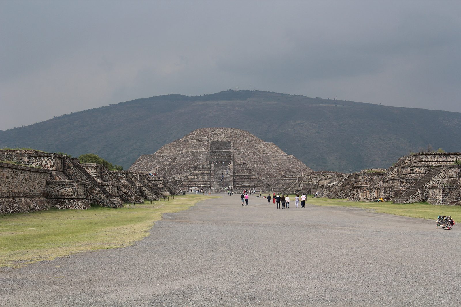 A pyramid at the end of a broad avenue, with a mountain rising directly behind it.