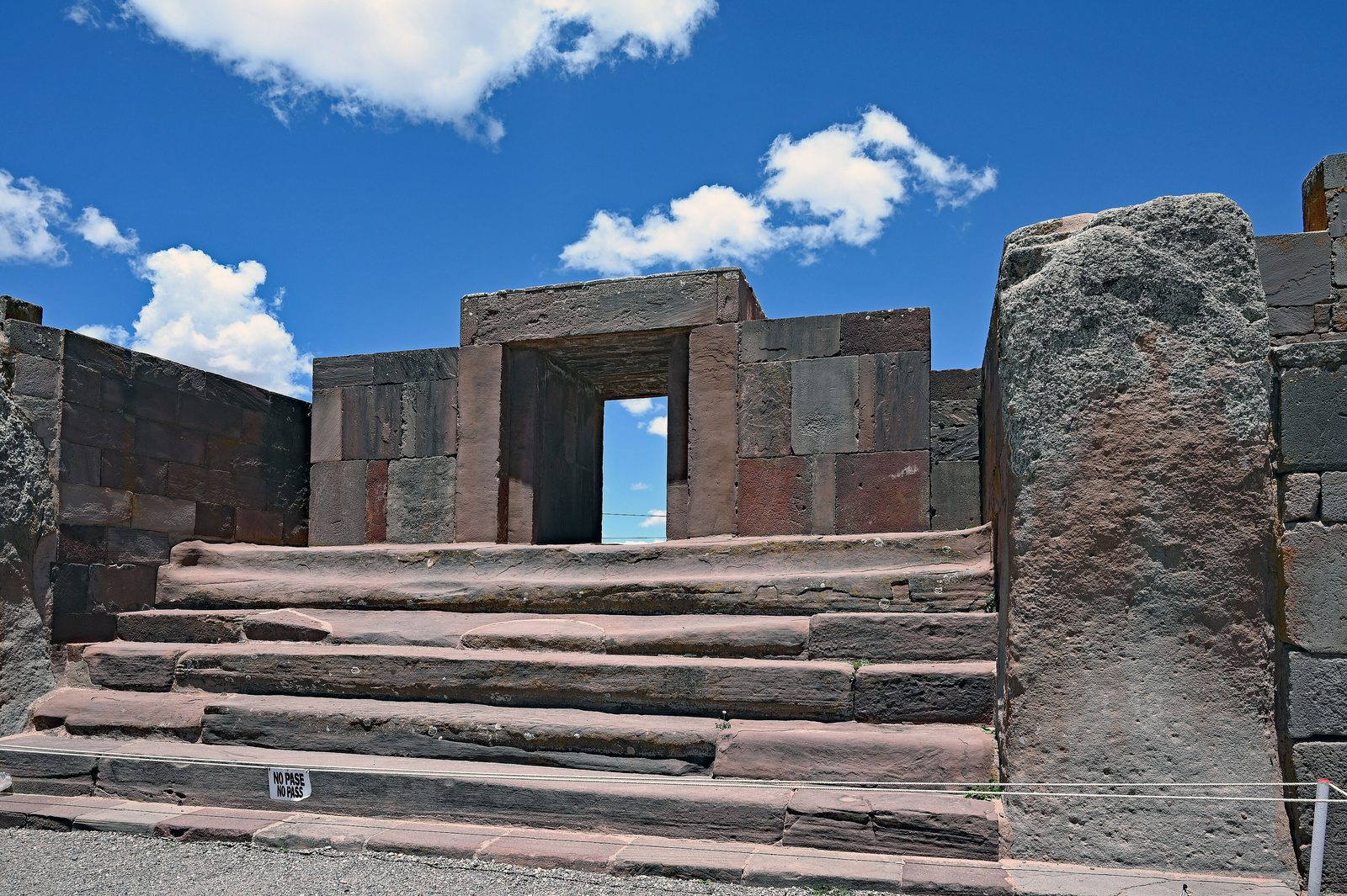 A broad stone staircase rising to a doorway framed by massive upright stones.