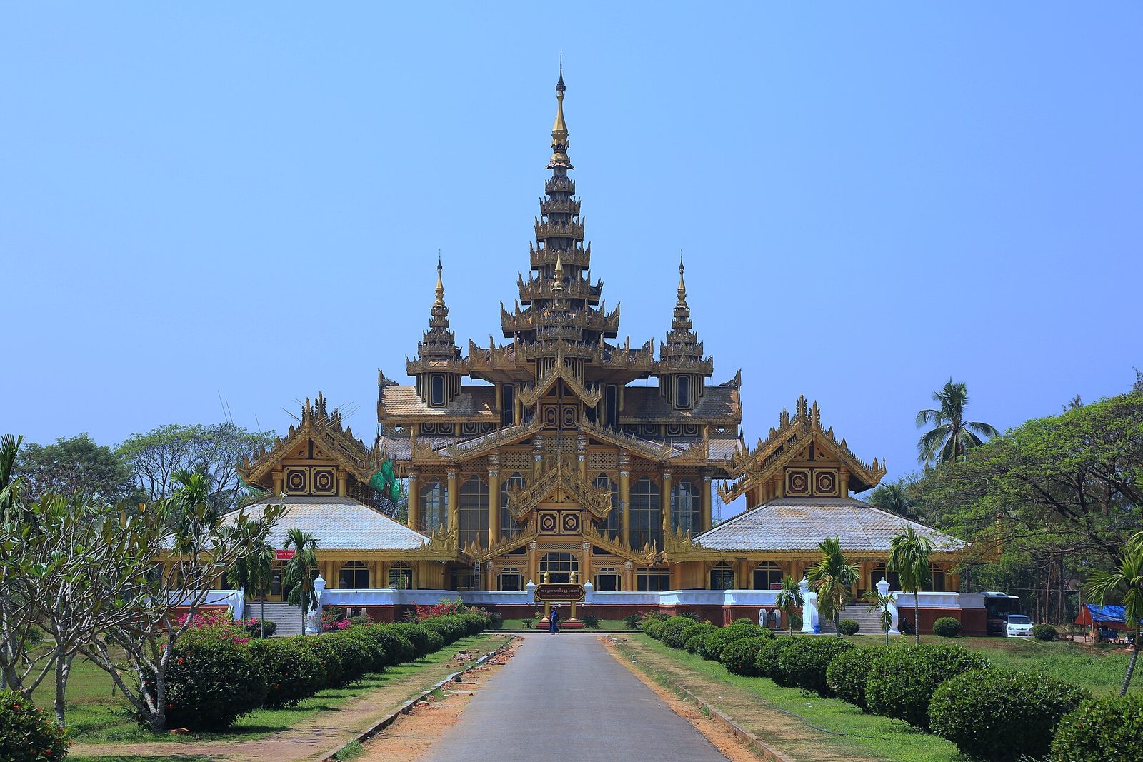 A gilded multi-roofed palace at the end of a straight avenue.
