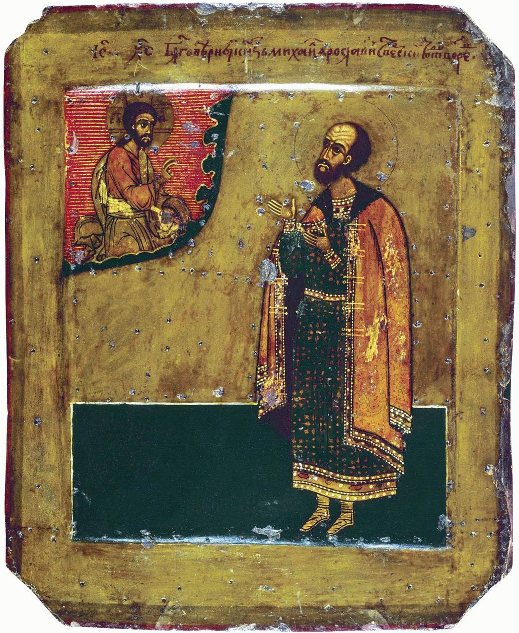 An icon of a prince in a long red cloak turning in prayer towards Christ in the upper corner, on a gold ground.