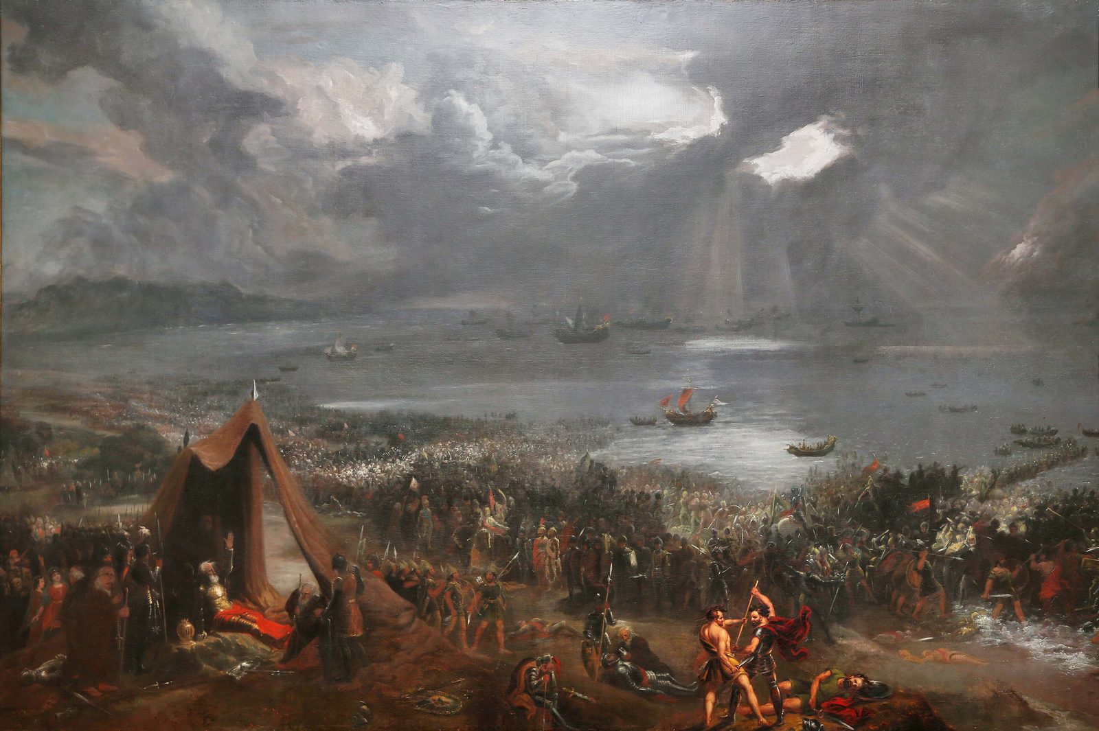 A large dark painting of armies fighting along a shore under a stormy sky, a tent and a fallen figure in the foreground.