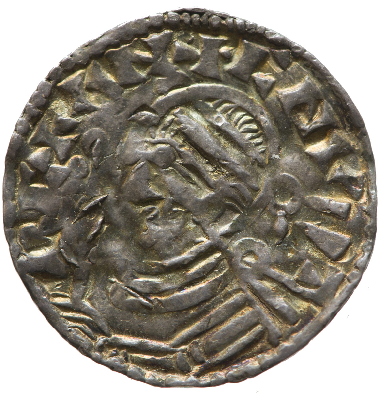 A worn silver penny with a crowned profile head facing left.