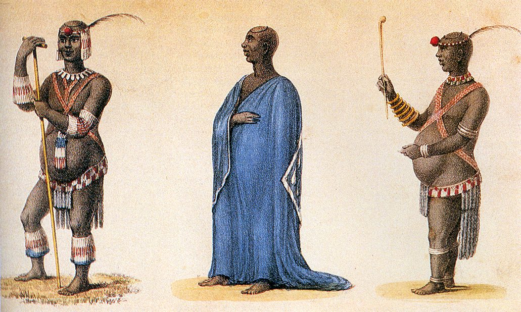 Three coloured figures of the same man: twice in beads, feathers and fringes holding a staff, and once in a long blue cloak.